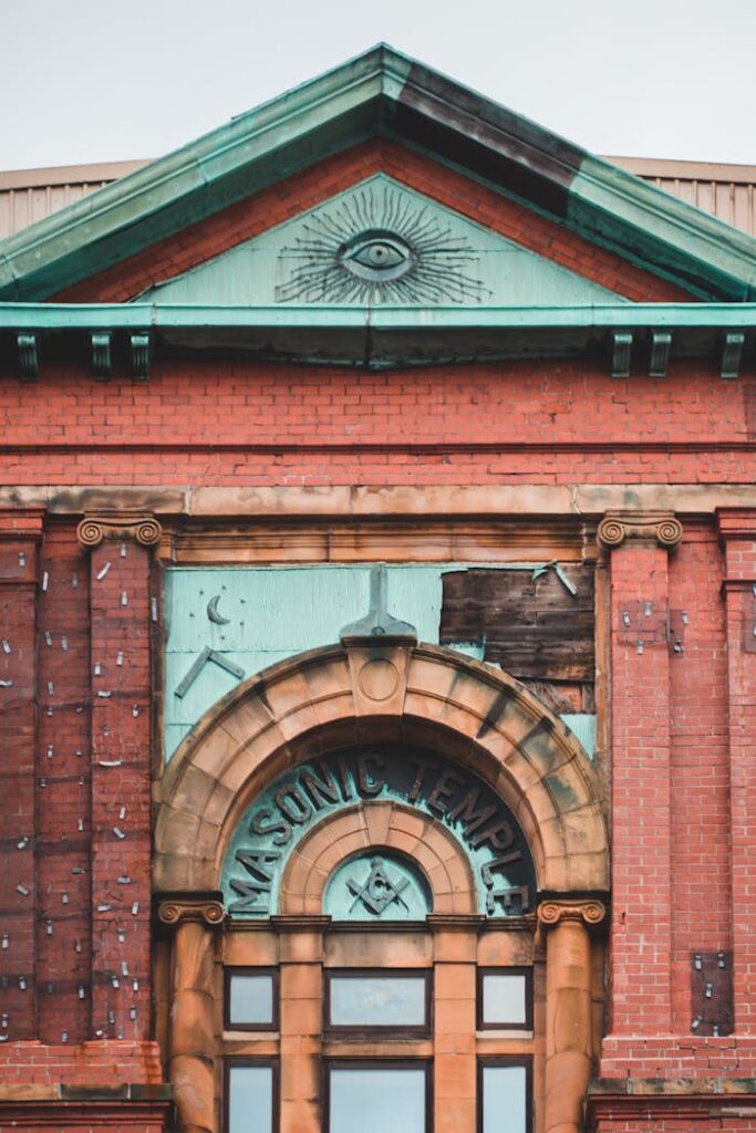Close-up of an ornate Masonic temple facade with symbolic architecture.